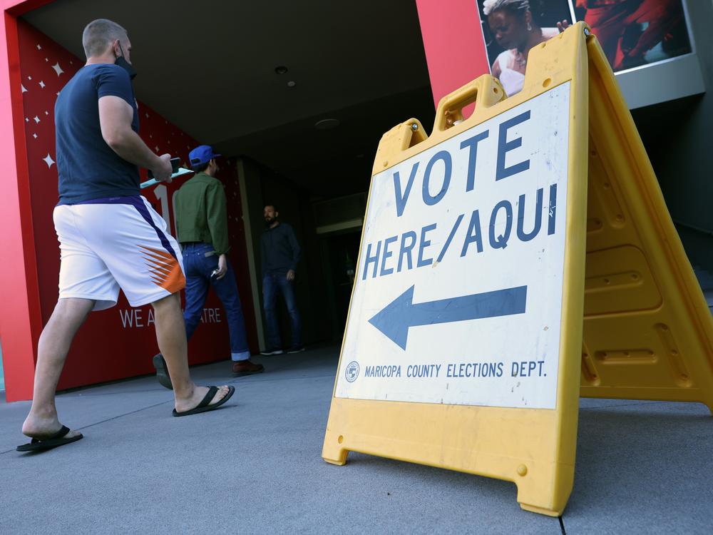 Voters head to a polling place in November 2022. Outside money is pouring into a Phoenix-area congressional district in a heated Democratic primary on Tuesday.