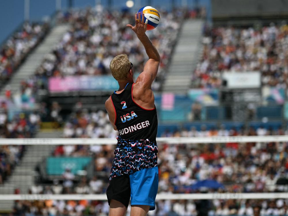 Chase Budinger serves the the ball during a beach volleyball match between France and USA on Monday.