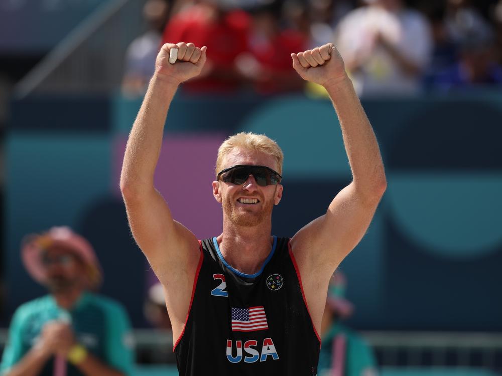 Chase Budinger celebrates after his team defeated a French duo during the Men's Preliminary Phase - Pool F match on Monday.