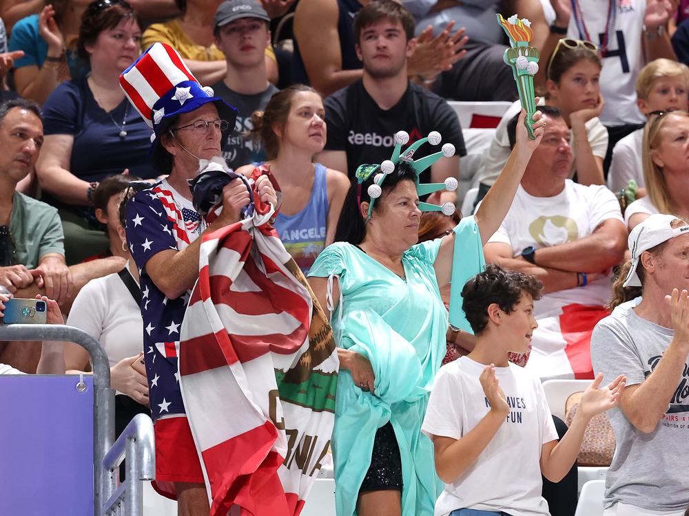 The Paris Olympics are bringing a ratings boost to NBC, the network says. Here, Team USA fans show their support during a men's preliminary volleyball match in Paris.