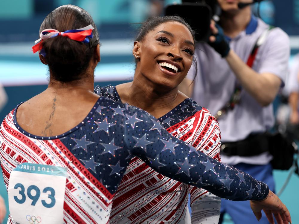 Simone Biles was all smiles with teammate Jordan Chiles after finishing her routine on the uneven bars during the women's gymnastics team final at the Olympic Games in Paris. 