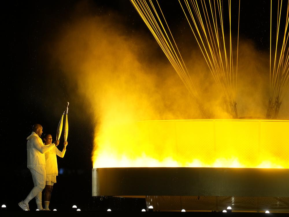The cauldron is lit by torch bearers Marie-Jose Perec and Teddy Riner in Paris, during the opening ceremony of the 2024 Summer Olympics, Friday, July 26, 2024.