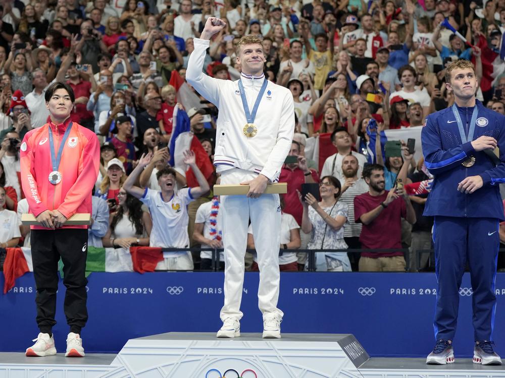 The new Michael Phelps may be a Frenchman. Gold medalist Leon Marchand stands with silver medalist Tomoyuki Matsushita, left, of Japan, and bronze medalist Carson Foster, of the United States, following the men's 400-meter individual medley final at the 2024 Summer Olympics on Sunday in Nanterre, France.