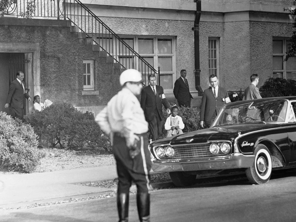 Six-year-old Leona Tate is escorted by U.S. Marshals from McDonogh 19 Elementary School in New Orleans on Nov. 15, 1960. 