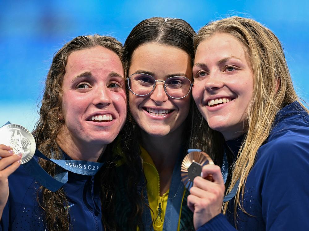 From left, U.S. silver medalist Regan Smith, Australian gold medalist Kaylee McKeown and U.S. bronze medalist Katharine Berkoff pose with their medals following the women's 100-meter backstroke swimming event during the Paris 2024 Olympic Games on Tuesday. Berkoff's bronze was not only the 3,000th medal for Team USA, but also the 600th Olympic medal earned by a USA swimming athlete.