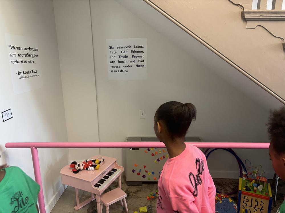  Students look at the area under the stairs where the 