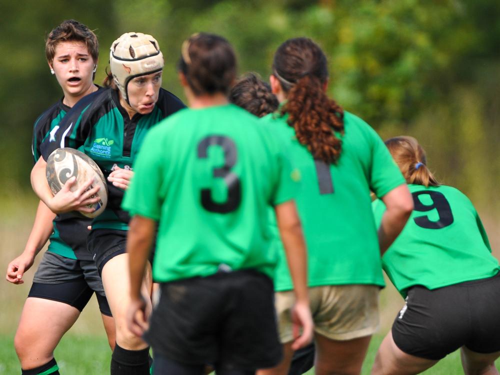  The author, Amy Morgan (in scrum cap), bashes into the defense with Frederick Women’s Rugby Football Club in September 2011.