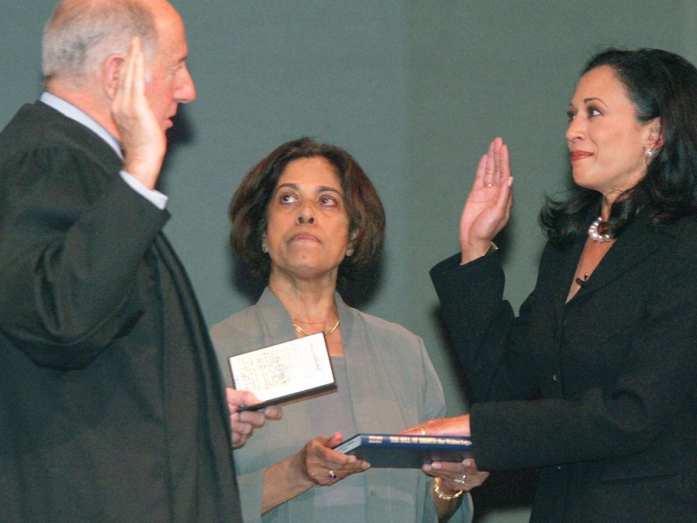 Harris takes the oath of office as San Francisco's district attorney on Jan. 8, 2004. Her mother, Dr. Shyamala Gopalan, holds a copy of the Bill of Rights.