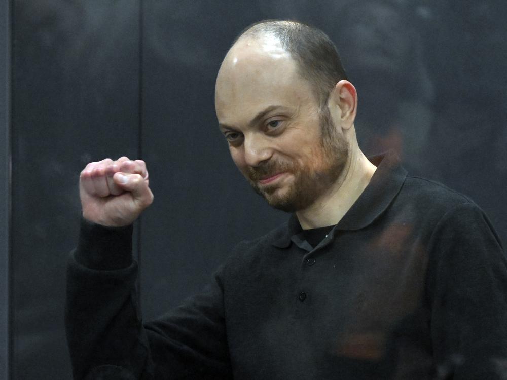 Russian opposition activist Vladimir Kara-Murza gestures while standing in a glass cage in a courtroom during announcement of the verdict on appeal at the Moscow City Court in Moscow on July 31, 2023. 