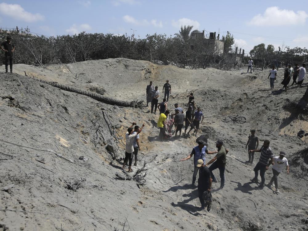 Palestinians search for bodies and survivors in a site hit by an Israeli bombardment on Khan Younis, southern Gaza Strip, on July 13 in which the Israeli military claim they killed the head of Hamas' military wing, Mohammed Deif.