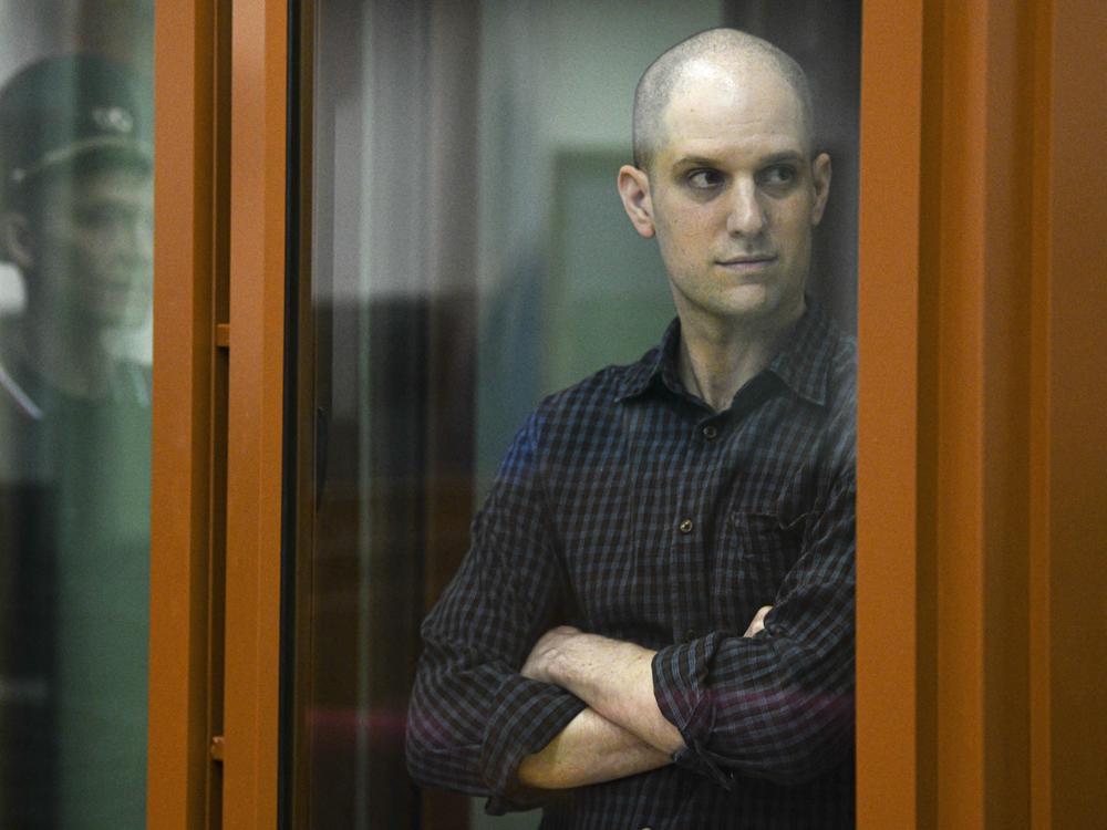 <em>Wall Street Journal </em>reporter Evan Gershkovich stands in a glass cage in a courtroom in Yekaterinburg, Russia, June 26.