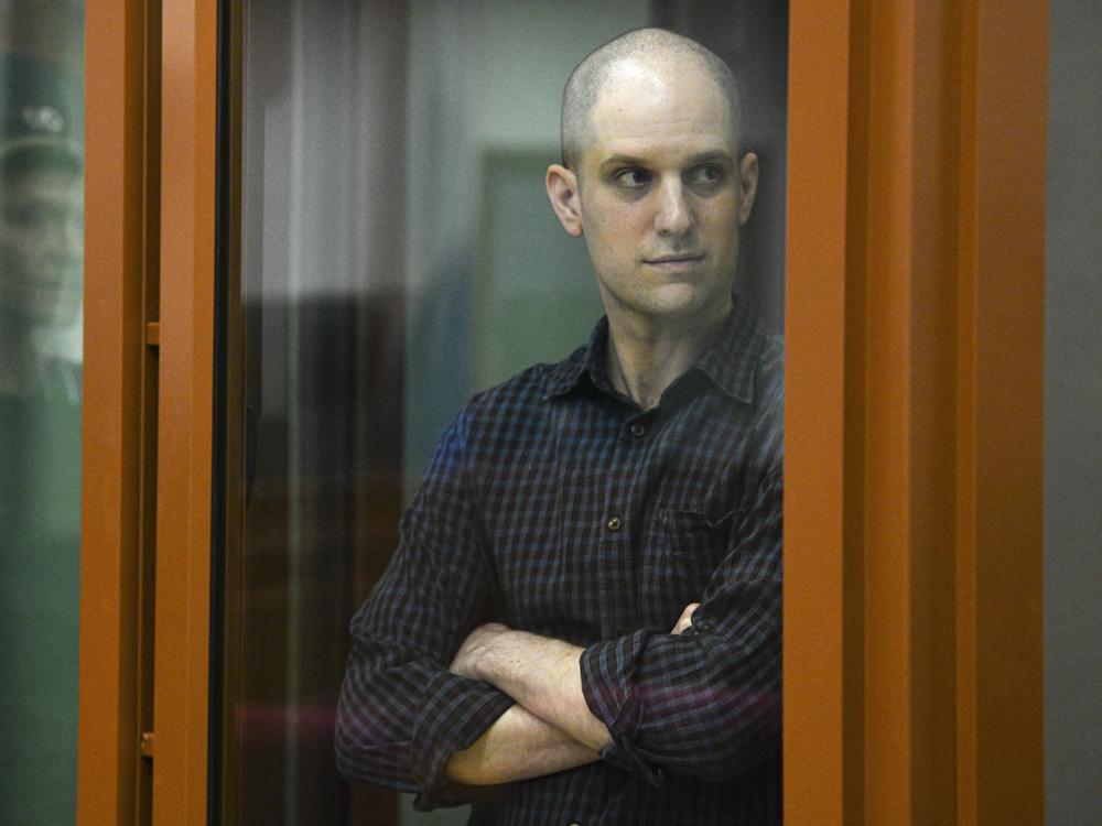 <em>Wall Street Journal </em>reporter Evan Gershkovich stands in a glass defendant's booth in a courtroom in Yekaterinburg, Russia, on June 26.