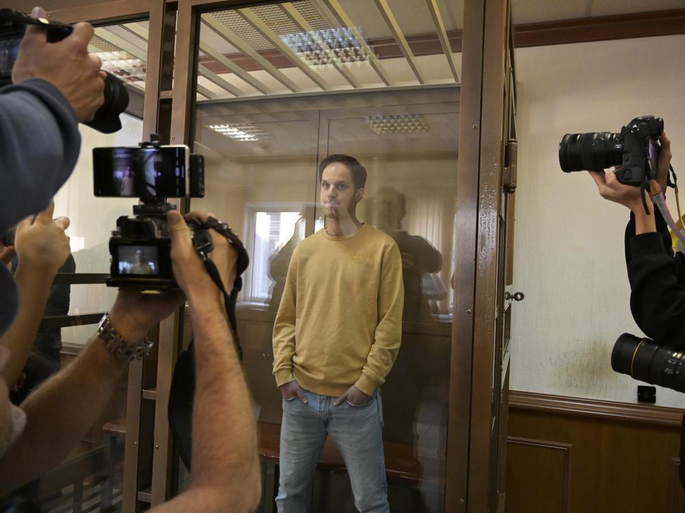 <em>Wall Street Journal</em> reporter Evan Gershkovich stands in the glass defendant's booth at the Moscow City Court, in Moscow on Sept. 19, 2023. 