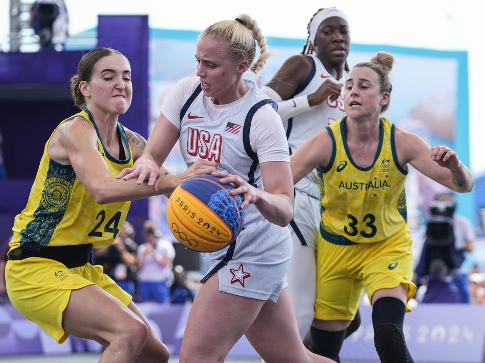 Australia's Anneli Maley (24) and Lauren Mansfield (33) defend Hailey van Lith, of the United States, in the women's 3x3 basketball pool round match Thursday during the 2024 Summer Olympics in Paris. Australia won 17-15.