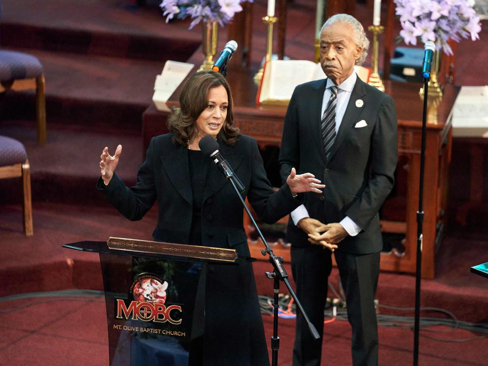 Vice President Harris speaks at the funeral service for Ruth Whitfield at Mt. Olive Baptist Church in Buffalo on May 28, 2022. The Rev. Al Sharpton stands behind her.