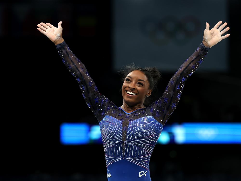 Simone Biles reacts after the balance beam portion of the women's gymnastics individual all-around competition at the Paris Olympics on Thursday. She's now won six Olympic gold medals — the most of any U.S. gymnast.