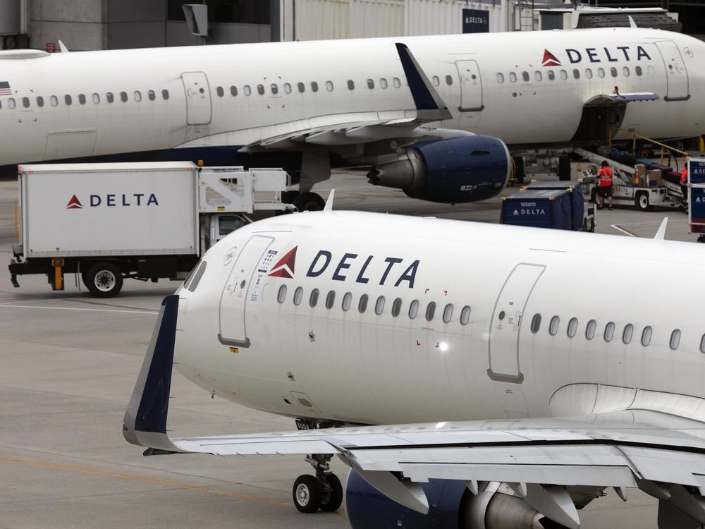 U.S. airline regulators have opened an investigation into Delta Air Lines, which was still struggling to restore operations on Tuesday, more than four full days after a faulty software update caused technological havoc worldwide and disrupted global air travel. Here, a Delta Air Lines plane leaves the gate on July 12, 2021, at Logan International Airport in Boston.