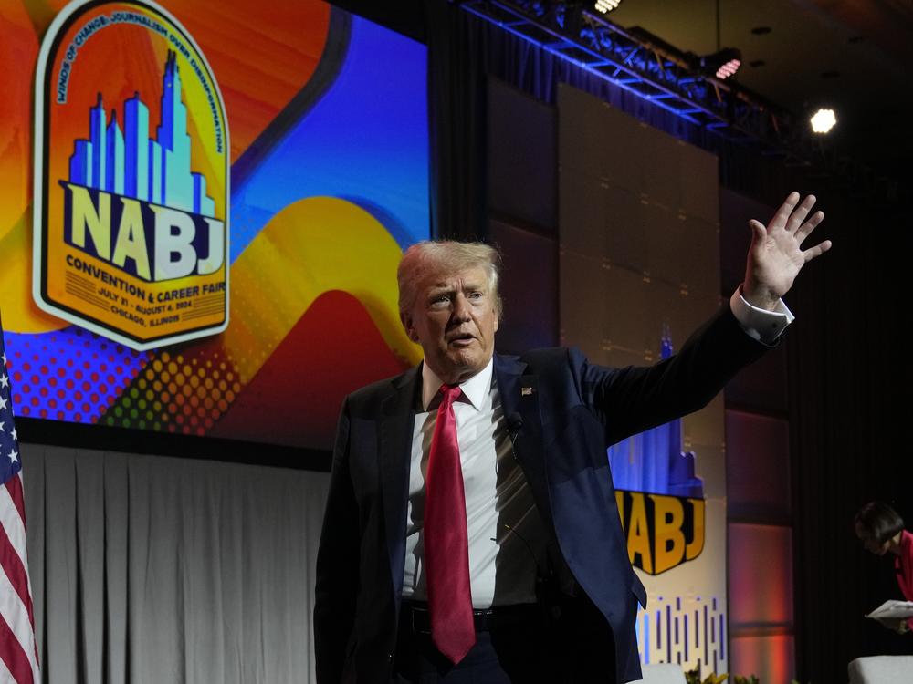 Former President Donald Trump walks off stage after speaking at the National Association of Black Journalists convention in Chicago on Wednesday.