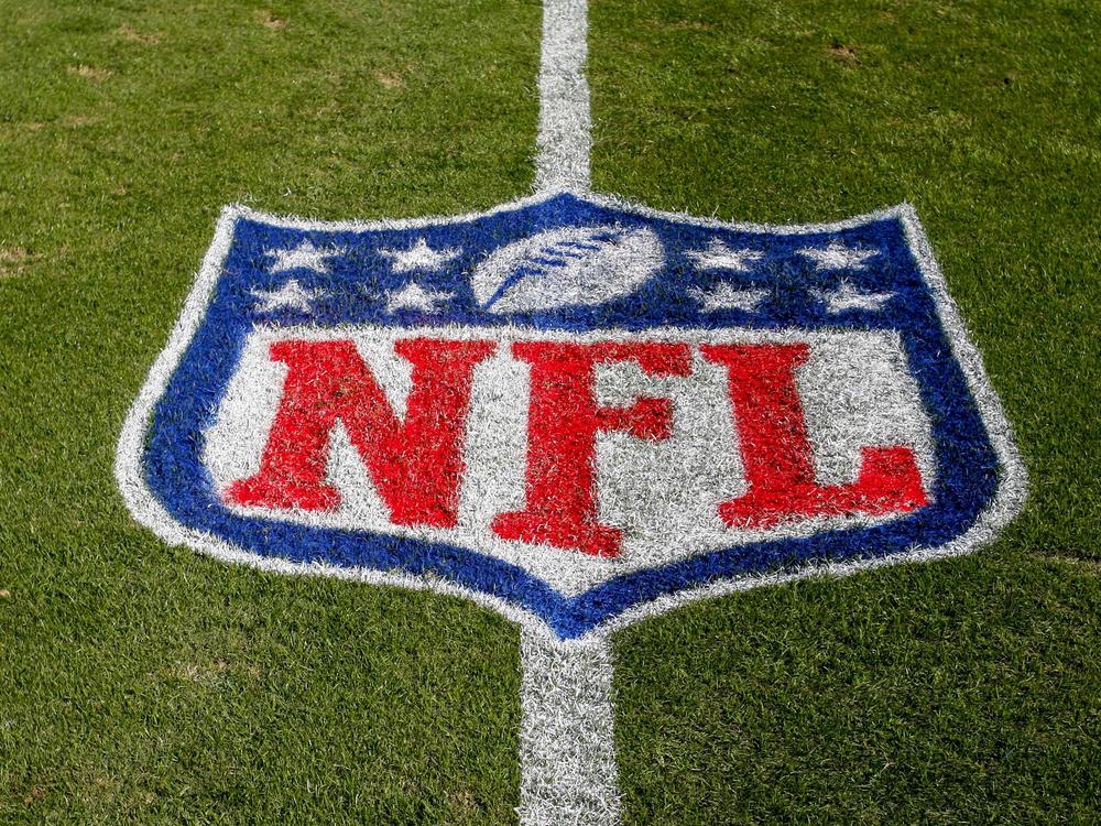 The NFL logo is displayed on the field in Charlotte, N.C., on Nov. 4, 2018.  The judge who presided in a class-action lawsuit filed by “Sunday Ticket” subscribers against the NFL said Thursday that the jury did not follow his instructions in determining damages.
