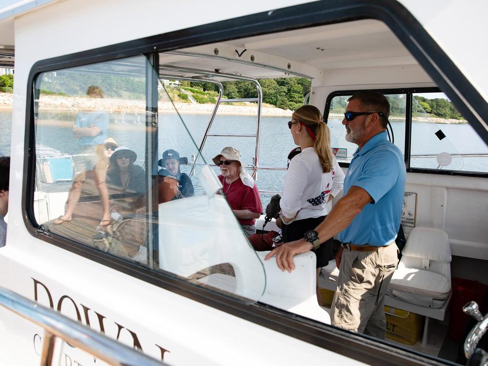 Before the tour leaves dock, Captain Nick Franco, right, waits to instructions from the spotter plane pilot on which direction to head first. From left to right, Felix Dunne, Kate Hales, Victoria and Olivia Germann, Walter Pytlak, and Brigitte “Gigi” Marino, the guide. 