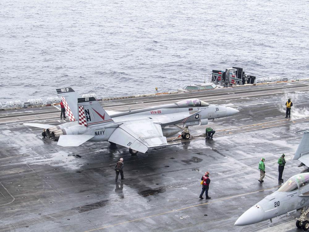 In this photo provided by the U.S. Navy, a U.S. fighter jet prepares to take off from USS Theodore Roosevelt aircraft carrier during the Freedom Edge exercise by the U.S., Japan and South Korea in Sea of Japan on June 28.