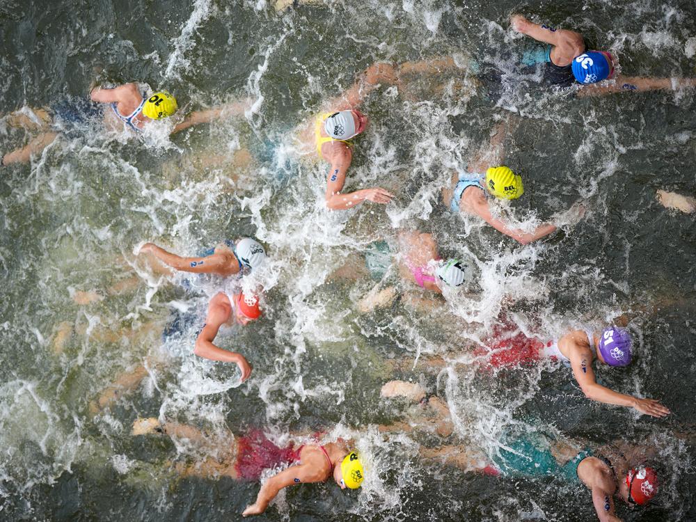 Women compete in the swimming leg of the women's individual triathlon competition Wednesday.