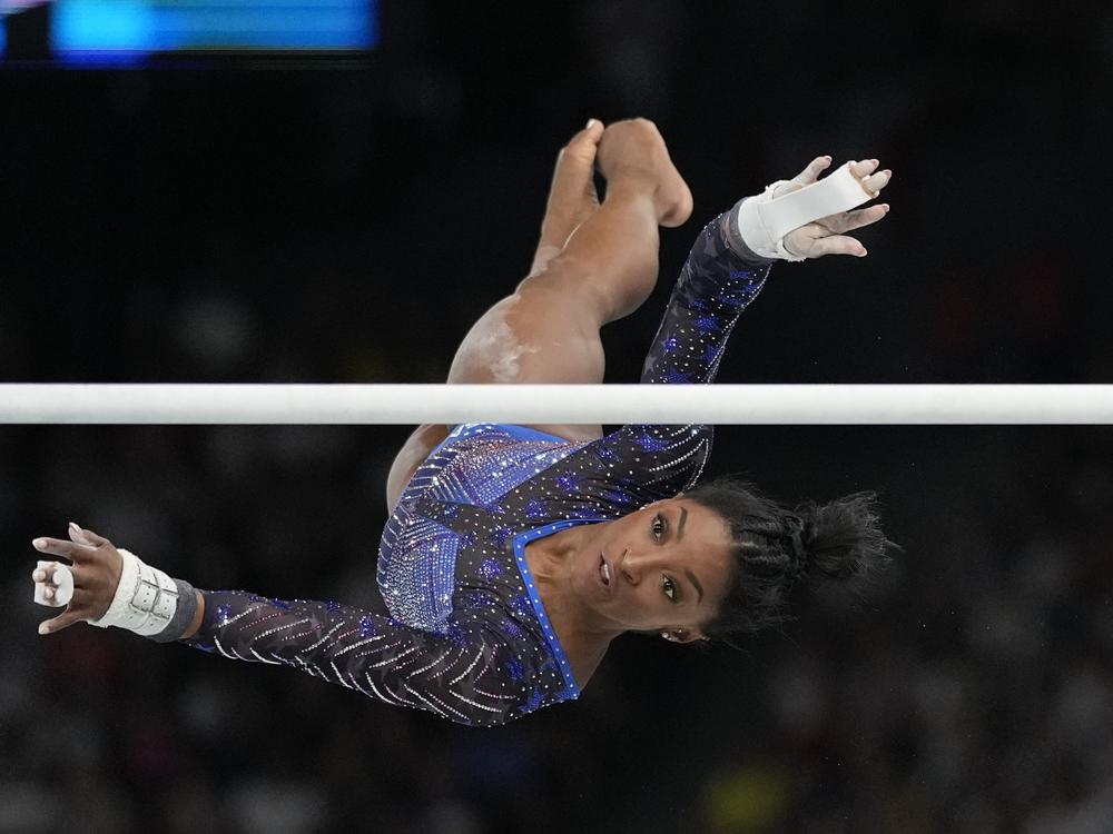 Simone Biles, of the United States, performs on the uneven bars during the women's artistic gymnastics all-around finals in Bercy Arena on Friday.