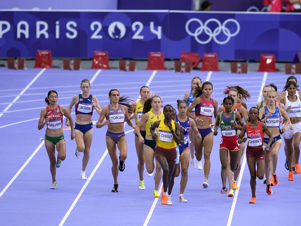 Runners compete during a heat in the women's 5000-meter run at the 2024 Summer Olympics, Friday, in Saint-Denis, France. 