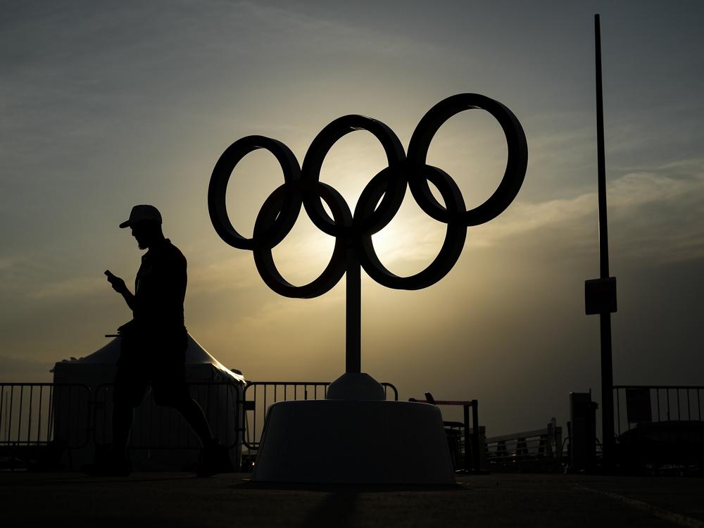 The sun sets behind the Olympic rings at the Olympic marina during the 2024 Summer Olympics, Friday, in Marseille, France. 
