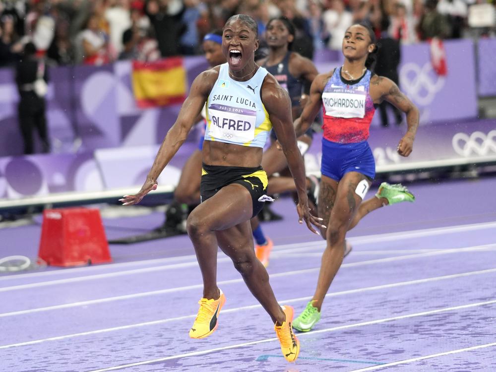 Julien Alfred, of Saint Lucia, celebrates after winning the women's 100-meters final at the 2024 Summer Olympics, Saturday, Aug. 3, 2024, in Saint-Denis, France. (AP Photo/Bernat Armangue)