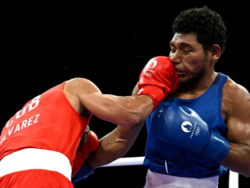 Cuba's Erislandy Alvarez connects with a punch on Papua New Guinea's John Ume in the men's 63.5kg preliminaries round of 32 boxing match on Saturday.