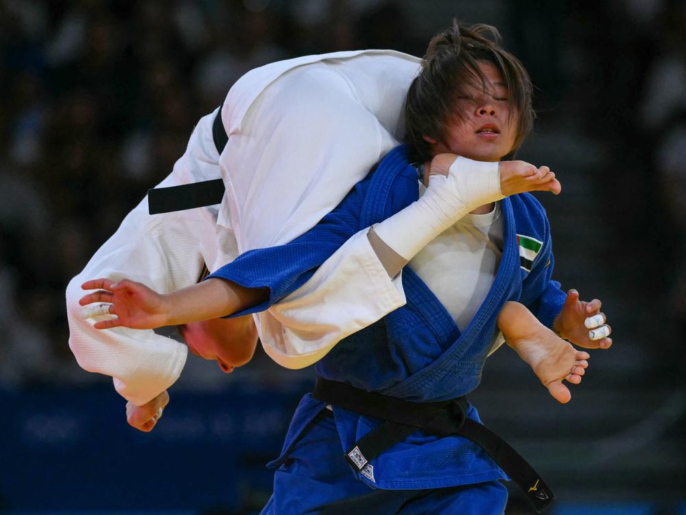 Germany's Mascha Ballhaus and the United Arab Emirates' Khorloodoi Bishrelt compete in the women's judo -52kg round of 16 bout on Sunday.