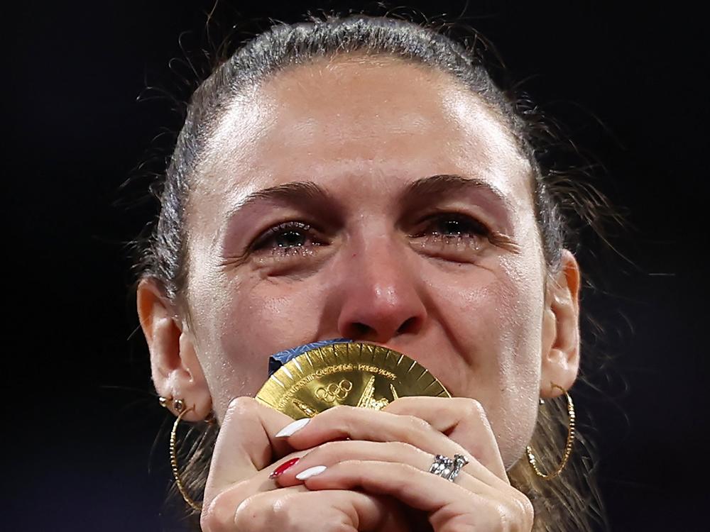 Gold medallist France's Manon Apithy-Brunet celebrates on the podium during the medal ceremony for the women's sabre individual competition on Monday.