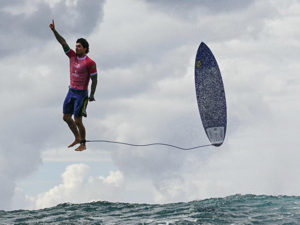Brazil's Gabriel Medina reacts after getting a large wave in the fifth heat of the men's surfing round 3 on Monday.