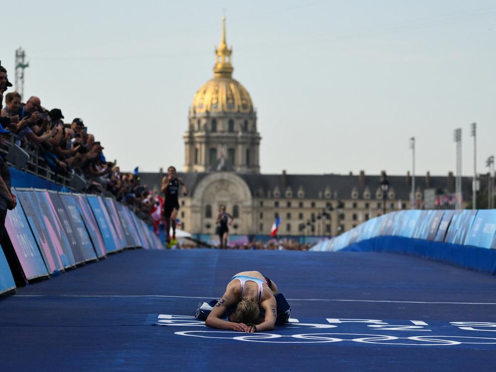France's Cassandre Beaugrand reacts after crossing the finish on the Pont Alexandre III at the end of the women's individual triathlon race on Wednesday.