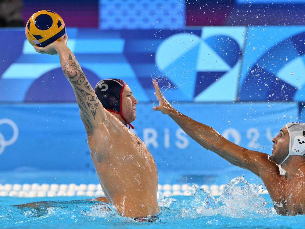Team USA's Hannes Daube shoots the ball in front of Greece's Ioannis Fountoulis in a men's water polo preliminary round Group A match Thursday.