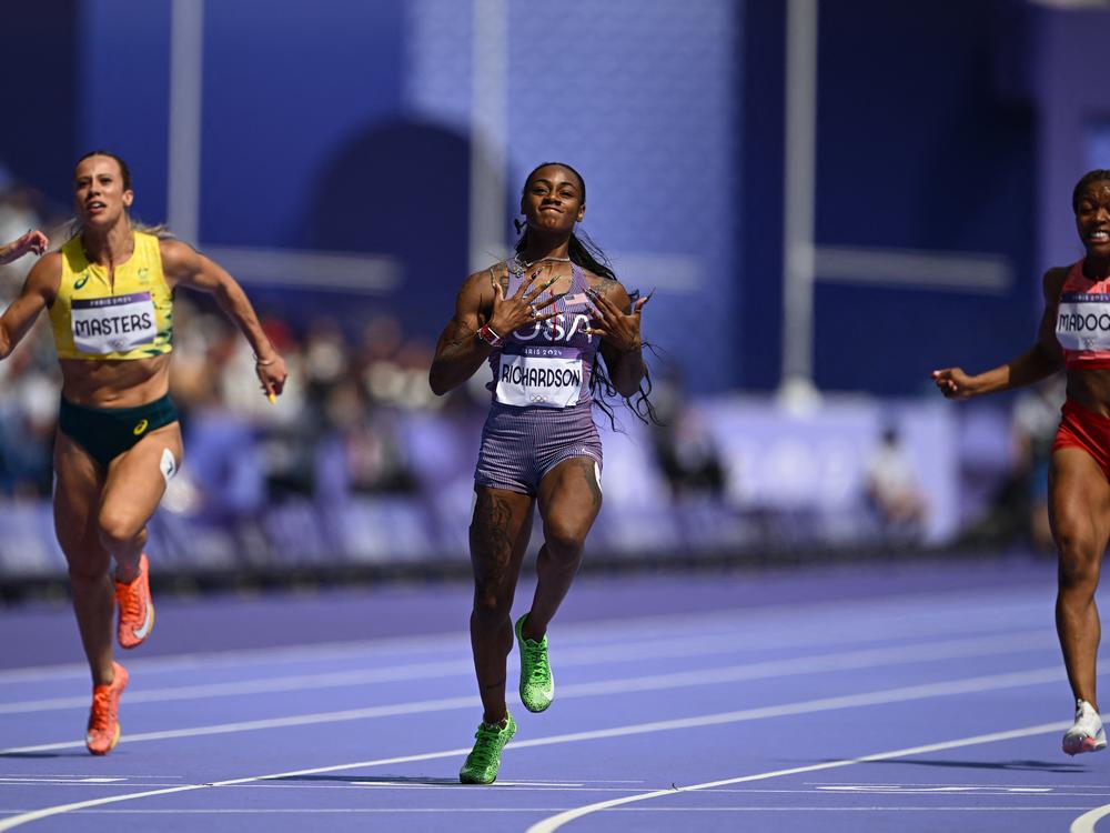 Sha'Carri Richardson, of the U.S., crosses the finish line to win past Australia's Bree Masters and Canada's Jacqueline Madogo in the women's 100-meter heat of the athletics event on Friday.