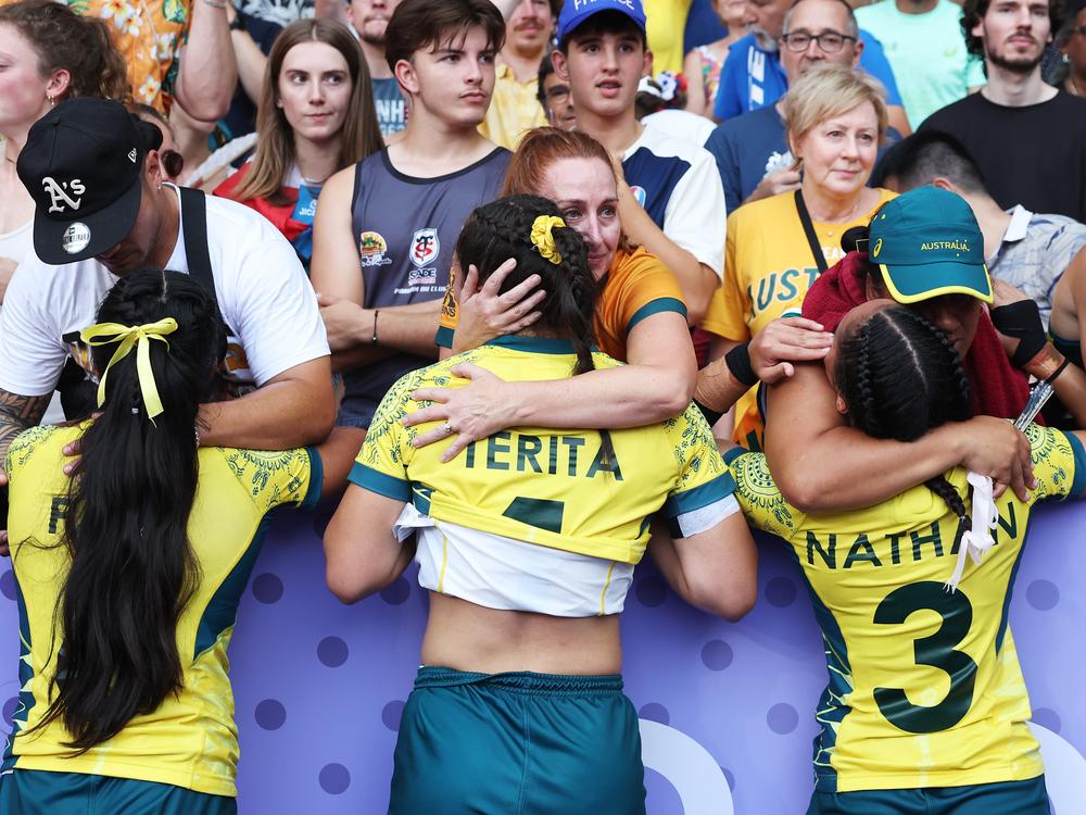 Team Australia's Sariah Paki, Bienne Terita and Faith Nathan are comforted by members of the crowd following their defeat during the women's rugby sevens bronze medal match with the United States on Tuesday.
