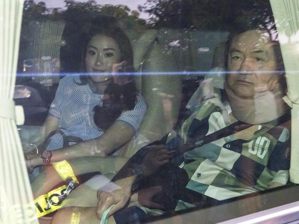 Former Thai Prime Minister Thaksin Shinawatra (right) sits in a vehicle with his daughter Paetongtarn in front of his residence after being released on parole, Feb. 18, in Bangkok, Thailand. Thaksin was released from Police General Hospital, where for the previous six months he had been serving time for corruption-related offenses.