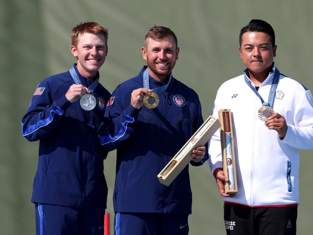 Gold medalist Vincent Hancock of Team United States (C), silver medalist Conner Lynn Prince of USA (L) and bronze medalist Meng Yuan Lee of Taiwan (R) celebrate on the podium at the Shooting Skeet Men’s medal ceremony on Saturday in Chateauroux, France.