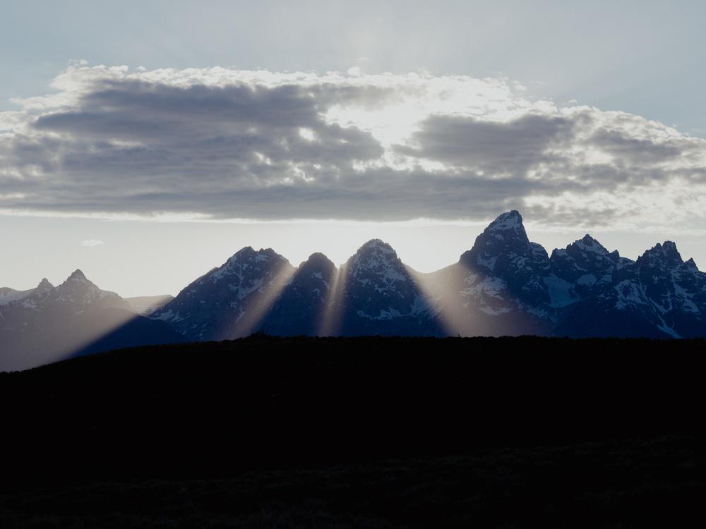  The sun sets behind the Grand Teton Mountains.
