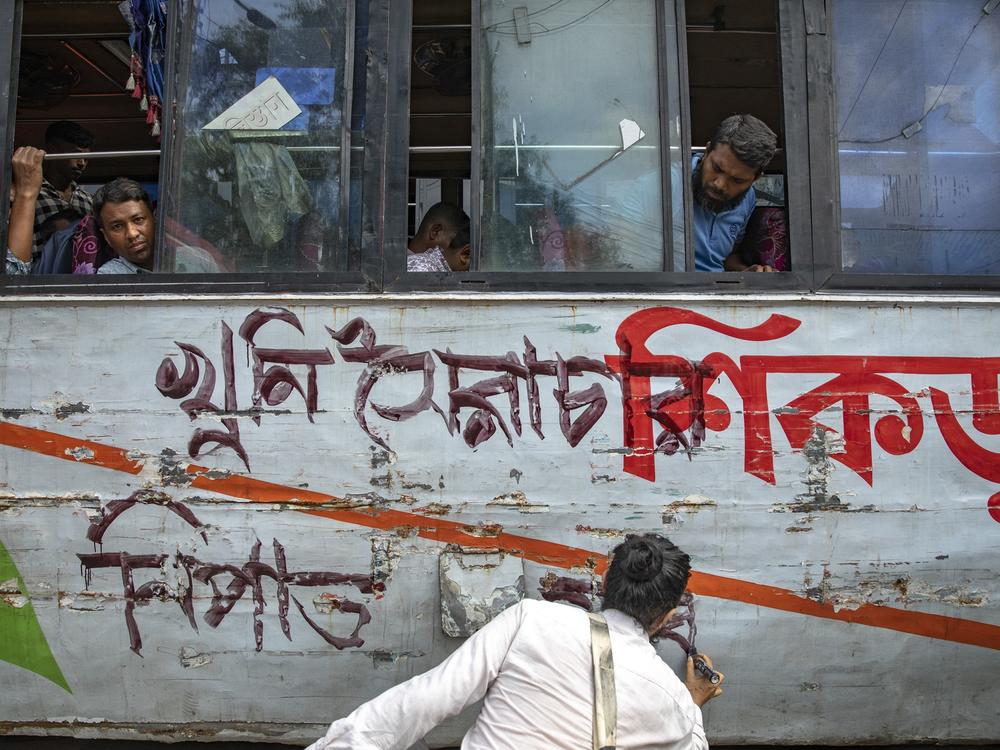 Cultural activists and members of civil society are painting on a local bus as they are staging a song march on July 30.