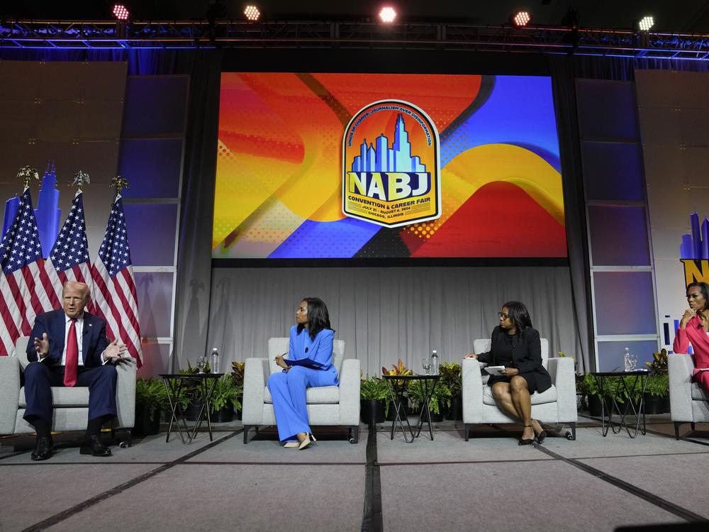 Former President Donald Trump appears on a panel at NABJ on Wednesday in Chicago. From left, ABC's Rachel Scott, Semafor's Kadia Goba and FOX News' Harris Faulkner moderated the event.