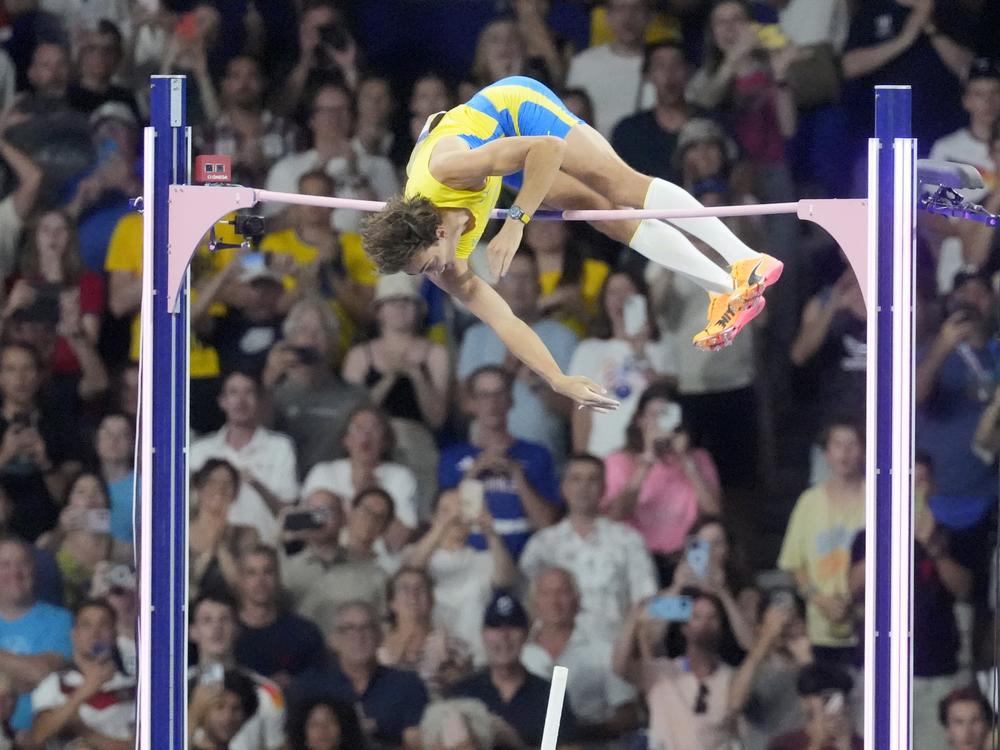 Armand Duplantis, of Sweden, clears the bar at 6.25m to set a new world record during the men's pole vault final at the 2024 Summer Olympics on Monday in Saint-Denis, France.