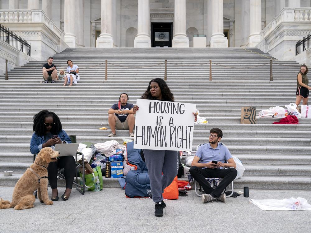 Representative Cori Bush, a Democrat from Missouri, center, joined by Congressional staffers and activists, protests the expiration of the eviction moratorium outside of the U.S. Capitol in Washington, D.C. on July 31, 2021. 