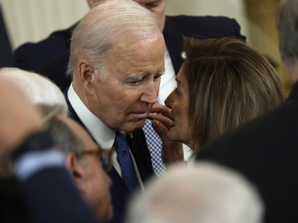 Joe Biden speaks to Nancy Pelosi in the East Room of the White House in March 2023.