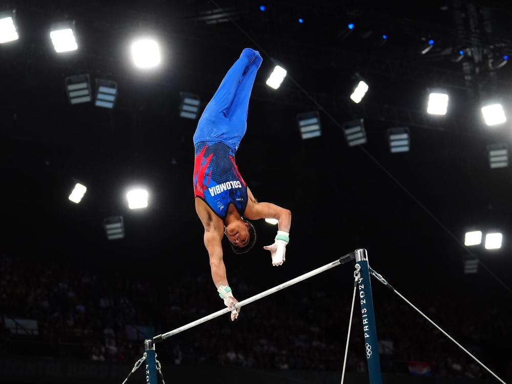 Colombia's Ángel Barajas jumped over fences as a kid, was spotted and sent to gymnastics club — and has now won Colombia's first medal in the sport. Here he is during the Men's Horizontal Bar Final at the Paris Olympics.
