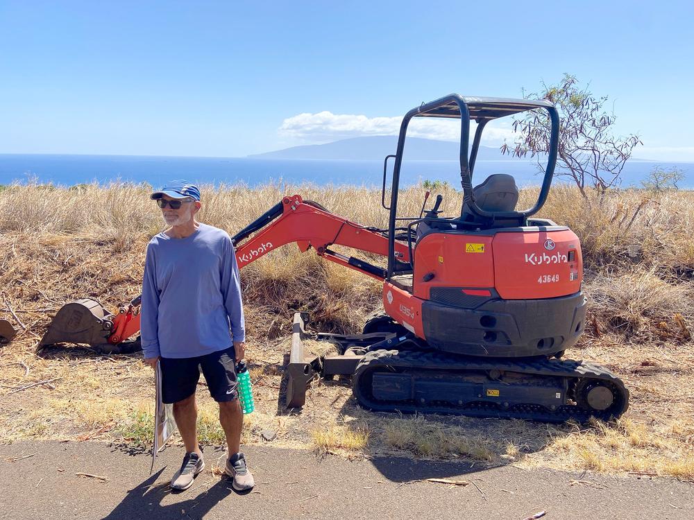 Gordon Firestein looks over brush-clearing work going on in his neighborhood, just south of Lahaina. The homeowners association there has passed new rules requiring residents to trim flammable brush.  