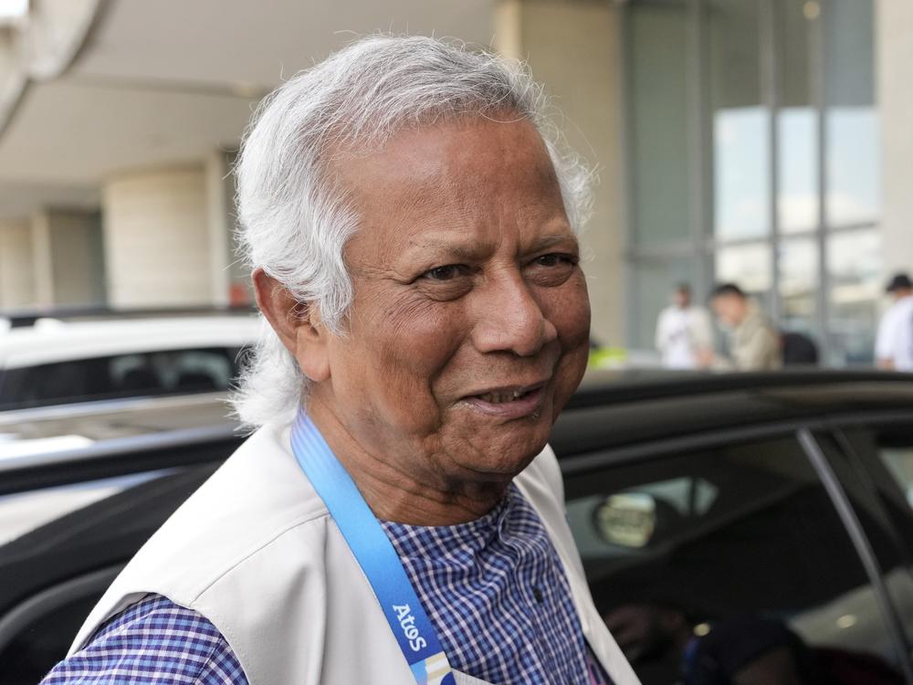 Nobel laureate Muhammad Yunus smiles upon his arrival at Charles de Gaulle's airport in Roissy, north of Paris, on Wednesday. 