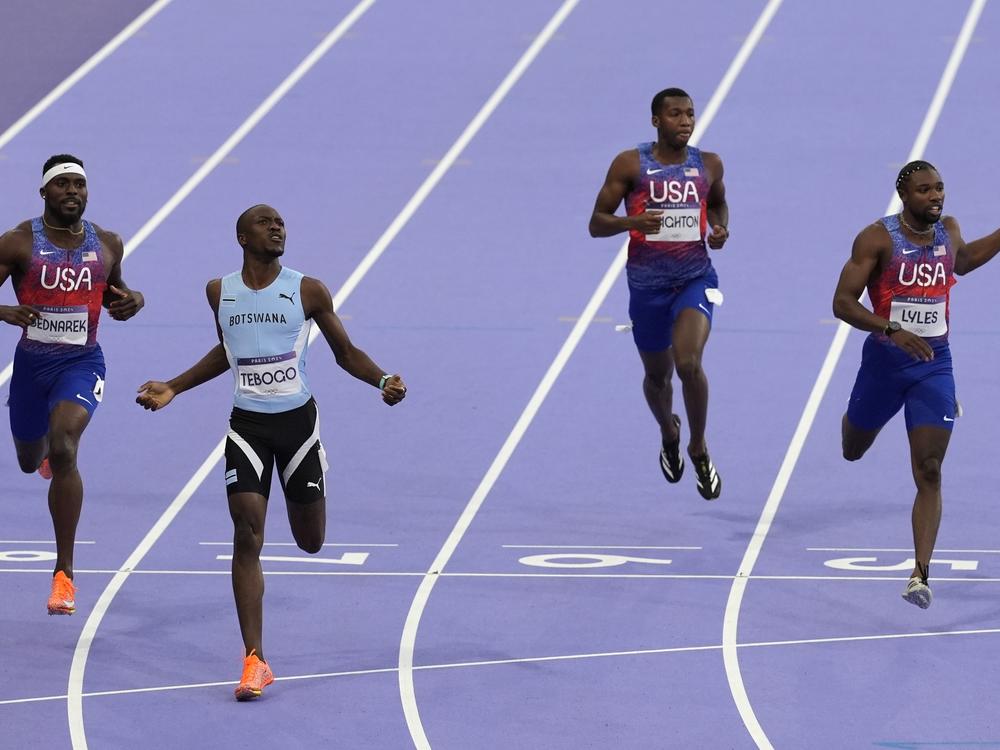 Letsile Tebogo, of Botswana, second left, won the men's 200-meters final at the Paris Olympics in Saint-Denis, France, on Thursday